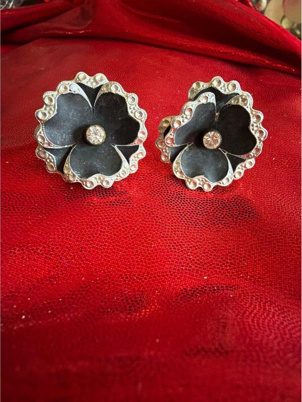 Vintage pressed tin screw-back earrings with black enamel floral design, made in